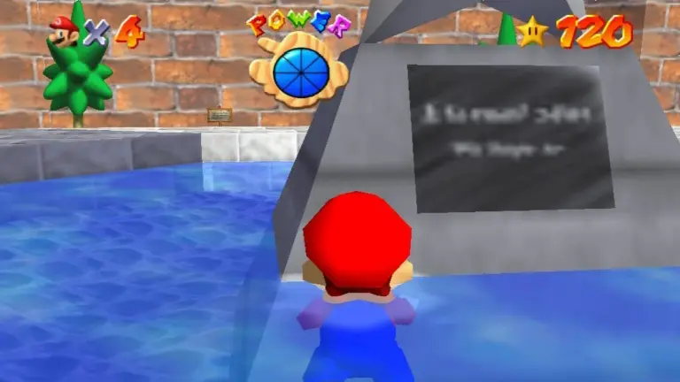 Mario face à la plaque gravée de la statue d'étoile dans la cour du château de Peach dans Super Mario 64 sur Nintendo 64